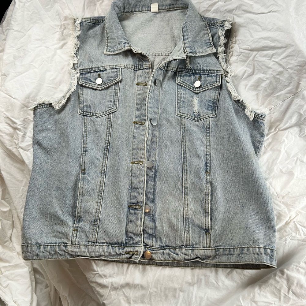Ladies Sleeveless distressed light denim vest with frayed armholes!